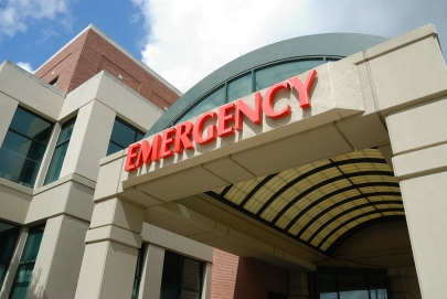 Emergency sign on exterior of hospital.