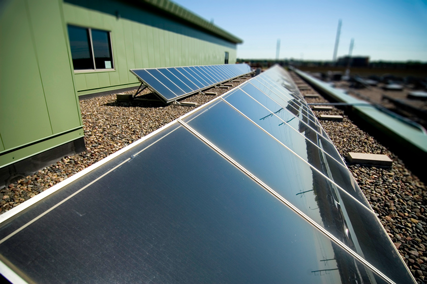 Close up of a photovoltaic or PV array stretching away across a roof top.