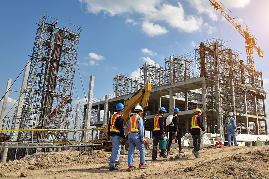 Construction workers entering a construction site.