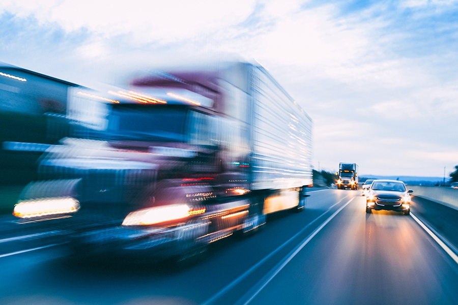 Vehicles moving quicly on a highway.