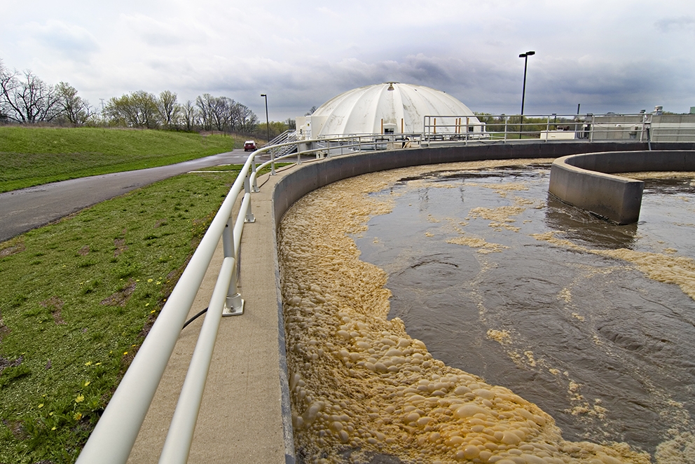 Wastewater treatment plant with white dome in background