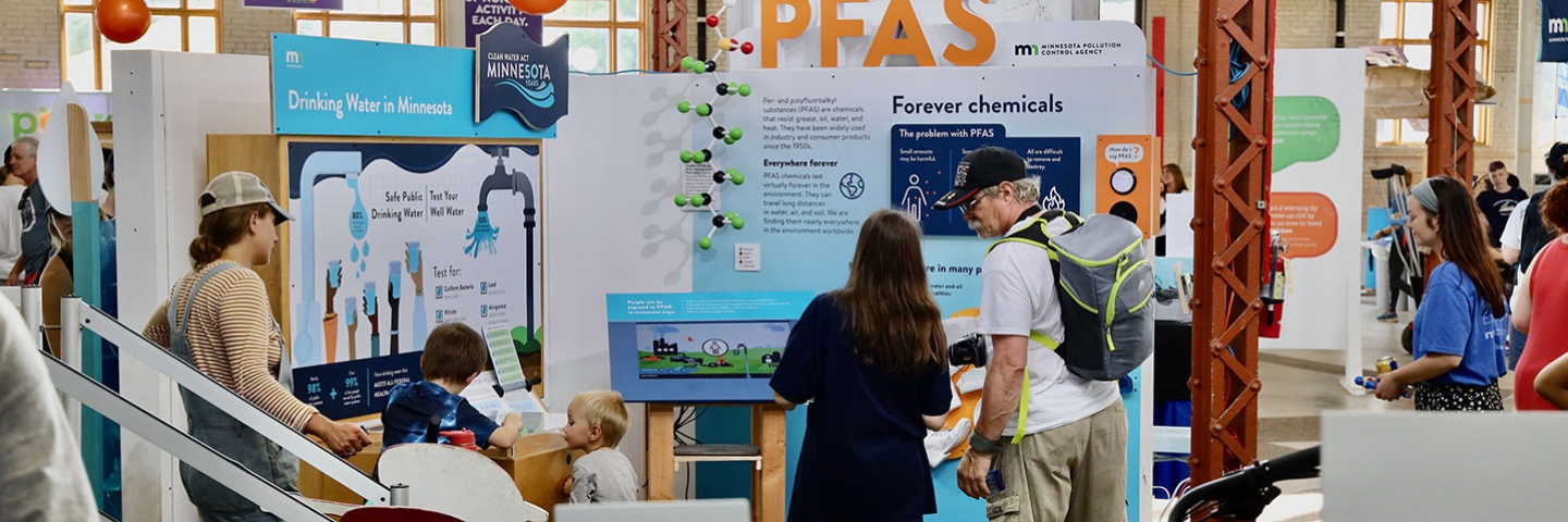 People interacting with a water exhibit at eco experience
