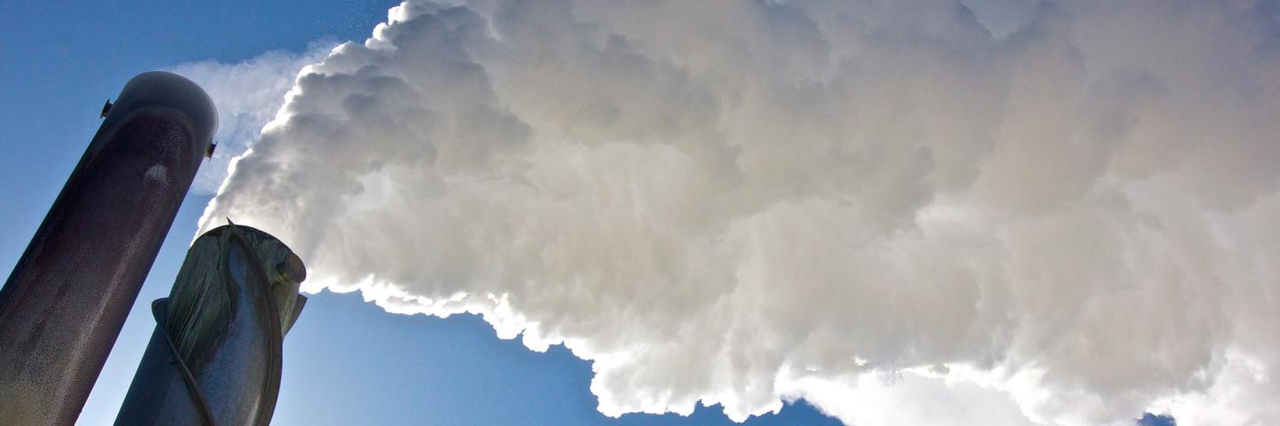 Smoke stacks emitting clouds of steam