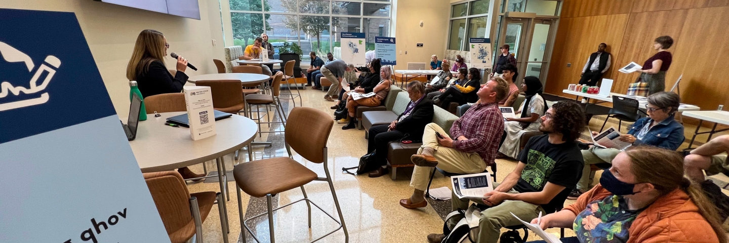 People listening to a speaker at a community meeting.