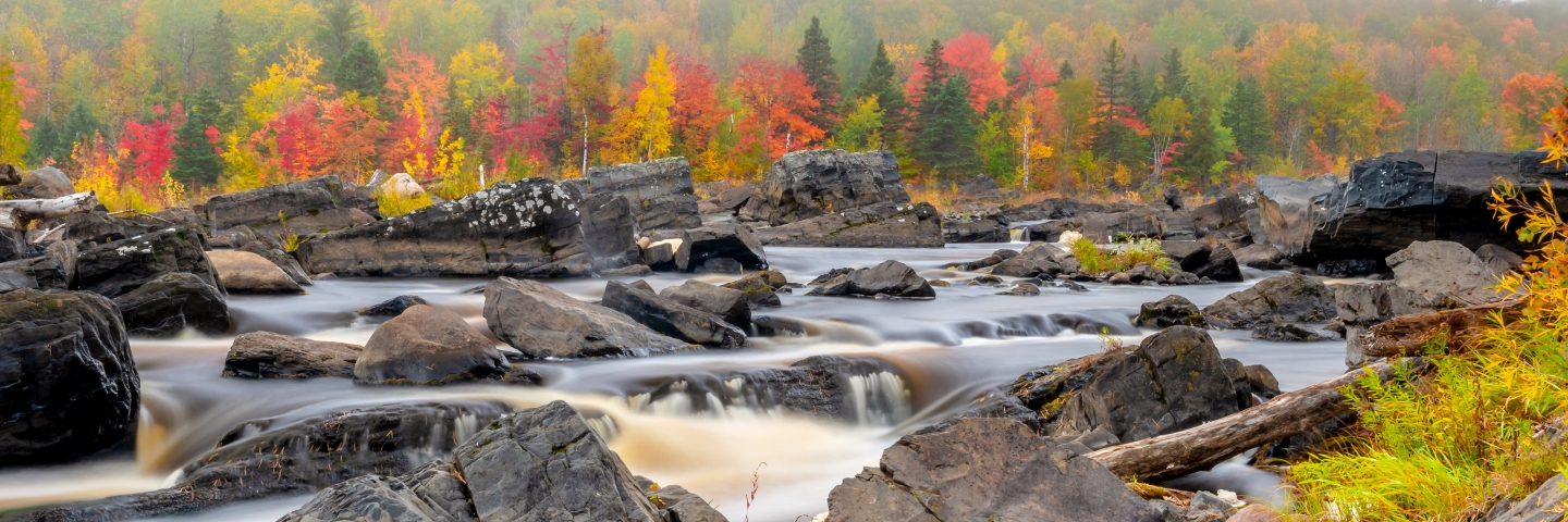 Autumn foliage along rocky St Louis River at Jay Cooke State Park.