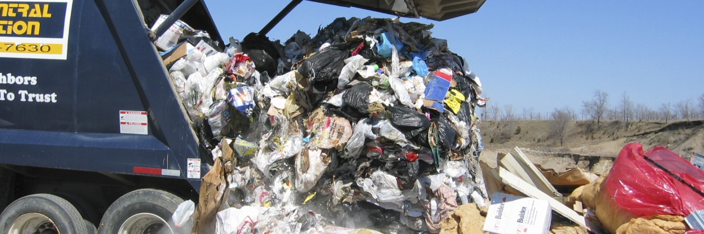 Garbage truck unloading at landfill