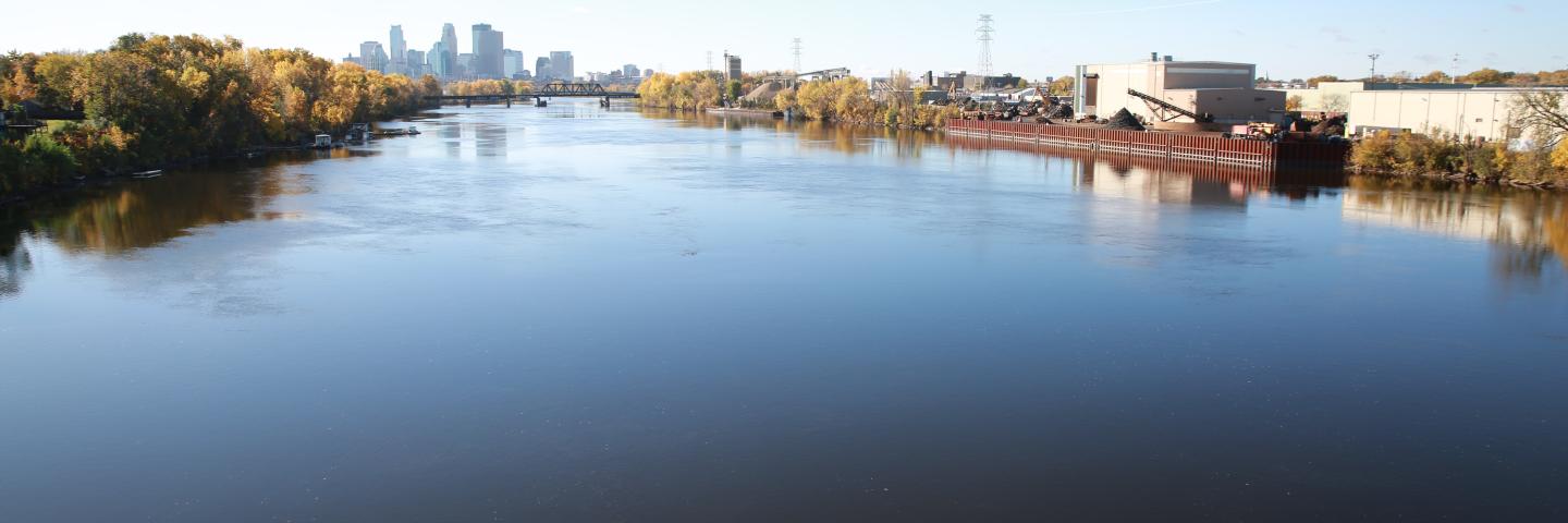 The wide Mississippi River with the Minneapolis skyline on the horizon.