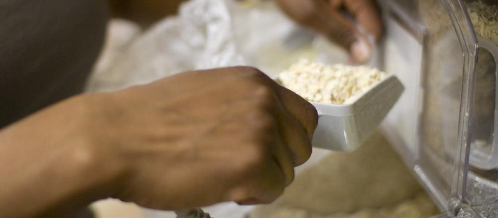 Hands scooping ingredients out of a bulk bin