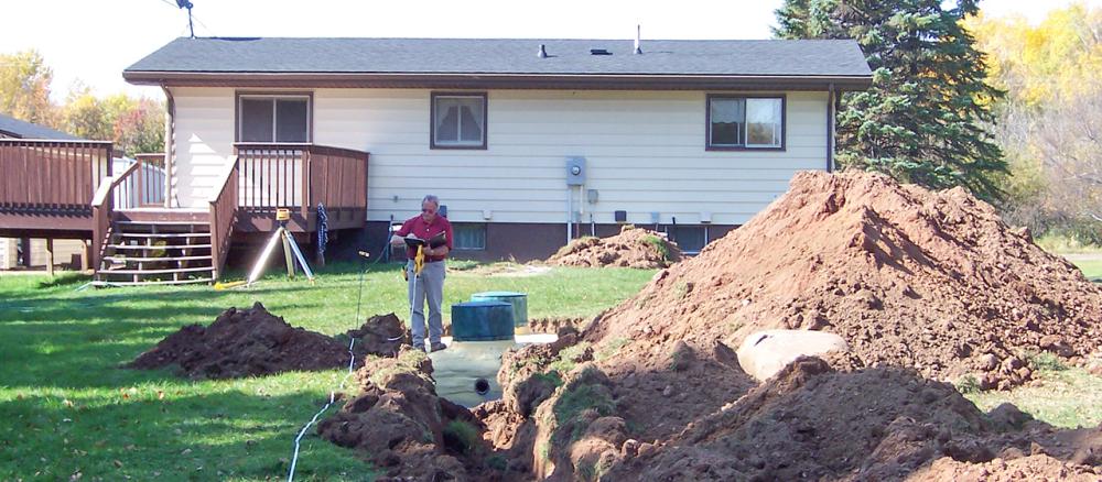 Backyard of home being dug up for a new septic system