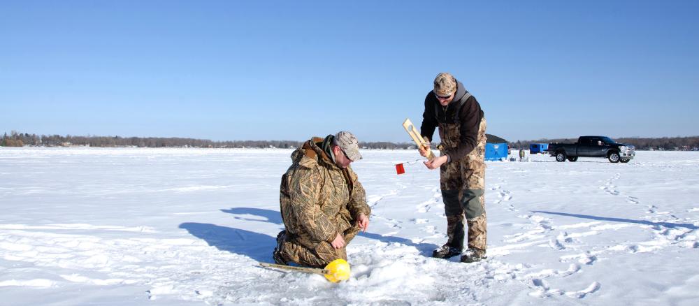 Ice fishing on a frozen Minnesota lake.