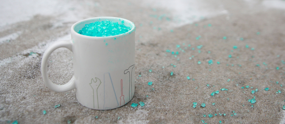 A ceramic coffee mug filled with sidewalk salt.