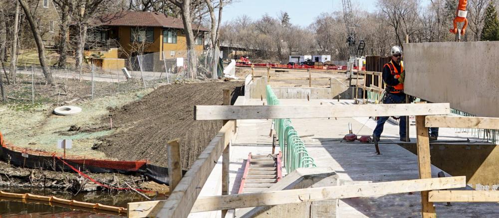 Best management practices on a construction site protect a stream bank from erosion along the route of the Southwest Green Line Light Rail Transit Extension