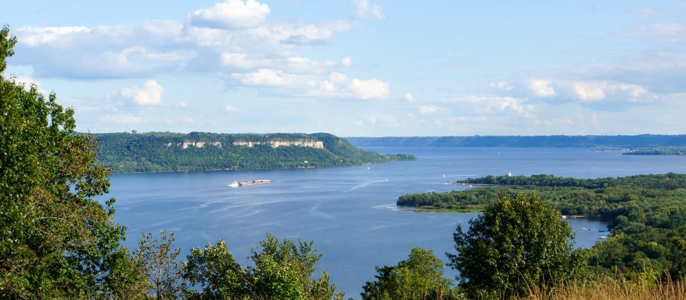 An overview of Lake Pepin with a barge in the distance, taken from a hill in Frontenac State Park.