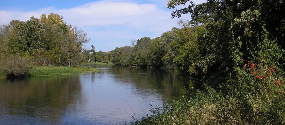 River bend running along tree lined banks.