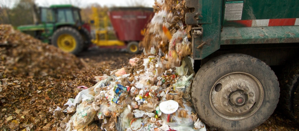 Collection truck dumping out recycling and organics material.
