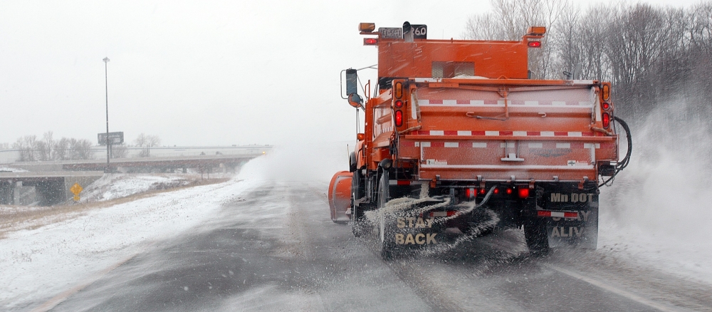 plow truck salting a highway