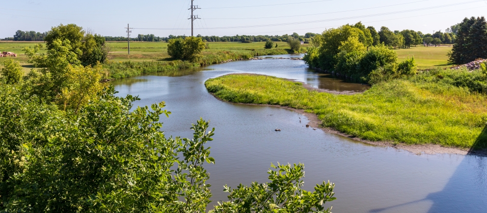 Small winding river passing through grassland.