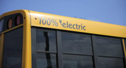 Close-up of school bus labeled 100% electric.