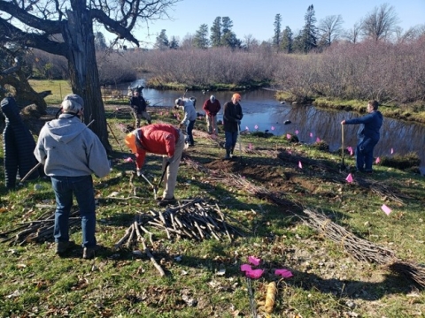 People cleaning up along the Kabekona River
