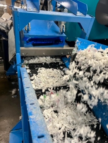 the magnetic separator at Poly Plastics above a conveyor of shredded plastic film