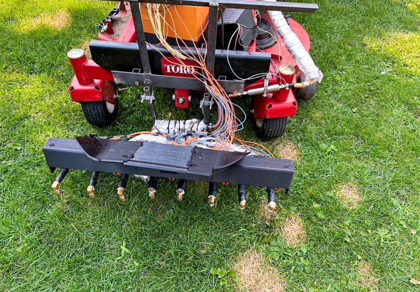 Prototype of a lawn mower attachment with steam nozzles.