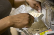 Hands scooping ingredients out of a bulk bin