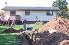 Backyard of home being dug up for a new septic system