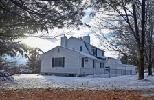 White rural house framed by trees