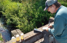 MPCA environmental specialist Kevin Stroom records data from water samples from Jenkins Creek