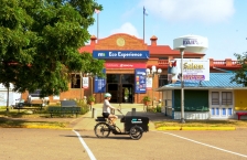 A person riding a cargo e-bike in front of the Eco Experience building at the Minnesota State Fair