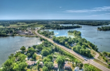 Aerial view of a highway bridging two connecting lakes.