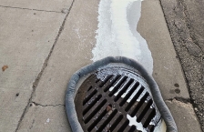 Cream runs down a gutter to a storm drain.