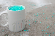 A ceramic coffee mug filled with sidewalk salt.