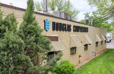 Light colored brick building with the name Douglas Corporation on the side.