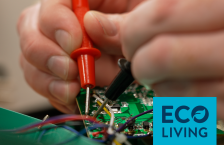 Close up of two hands working with tools to fix a motherboard.