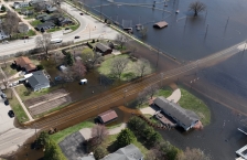 Aerial view of a river flooding a town.