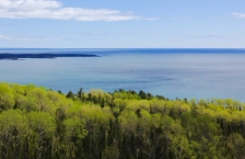 Aerial view over Lake Superior with trees in foreground. 