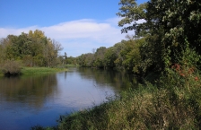 River bend running along tree lined banks.