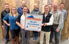 Group of people holding a sign that reads Storm Ready, we are storm ready, be prepared.