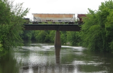Railroad cars on bridge crossing a river.