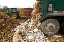 Collection truck dumping out recycling and organics material.