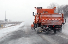 plow truck salting a highway