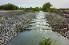 Stream with rock and gravel ridges crossing stream