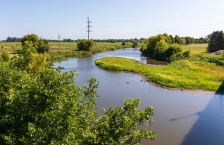 Small winding river passing through grassland.