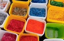 Buckets containing shredded plastic in a variety of bright colors.