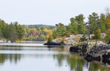 Person fishes from rocky shore of Thompson Reservoir