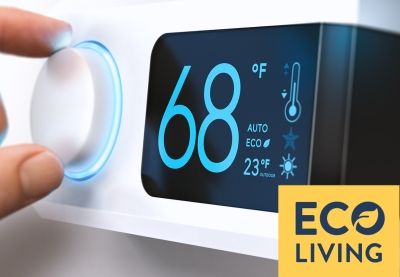 Hand adjusting the temperature on a thermostat.