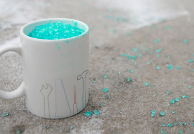 A ceramic coffee mug filled with sidewalk salt.
