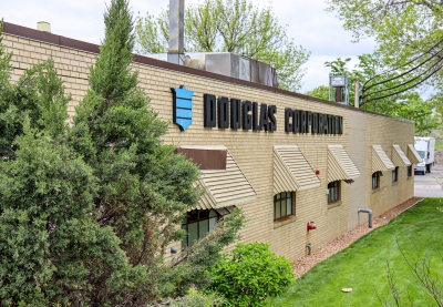 Light colored brick building with the name Douglas Corporation on the side.