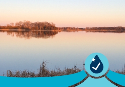 A very calm, still lake at sunset in autumn.
